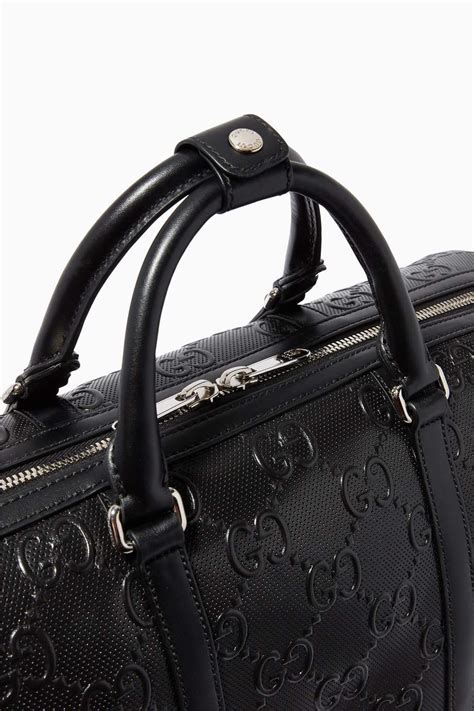 gucci embossed duffle bag.